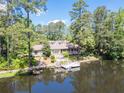 Stunning lakefront home with a private dock and a charming cottage-style design, perfect for relaxation at 127 Hamby Ln, Social Circle, GA 30025