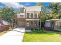 Two-story home boasts a spacious driveway, garage, and charming two-story balcony at 1464 Ezra Church Nw Dr, Atlanta, GA 30314