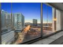 View from inside a condo looking at the bright, lighted buildings and skyline at dusk at 215 Piedmont Ne Ave # 1608, Atlanta, GA 30308