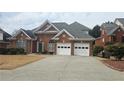 Attractive brick home with a well-kept lawn and a convenient two-car garage at 2604 Harman Park Cir, Duluth, GA 30097