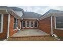 An exterior view of the brick patio featuring an overhang and several windows at 2604 Harman Park Cir, Duluth, GA 30097