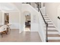Elegant foyer with hardwood floors, wainscoting and staircase with iron balusters at 3637 Green Pine Way, Suwanee, GA 30024