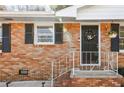 Close up of brick home with front door, shutters, and manicured steps at 4101 Spring Meadow Rd, Tucker, GA 30084