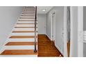 Hallway with hardwood floors and staircase leading to the upper level at 5660 Garden Cir, Douglasville, GA 30135