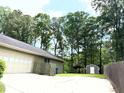 This property features a storage shed, lots of trees, and a sprawling backyard at 1312 La Mesa Dr, Lawrenceville, GA 30043