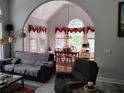 Comfortable living room with an archway to the dining area featuring large windows at 1470 Sweet Bottom Sw Cir, Marietta, GA 30064