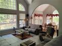 Bright living room with large windows, an archway, and a view of the outdoor space at 1470 Sweet Bottom Sw Cir, Marietta, GA 30064
