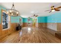 Spacious living room with hardwood floors, wainscoting, and stylish light fixtures at 3192 Highway 411 Ne, White, GA 30184