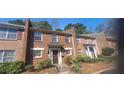 Brick townhome featuring an inviting entrance with mature landscaping and an elegant design at 3307 York Pl, Decatur, GA 30032