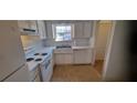 Traditional kitchen featuring white cabinets, a double sink, and standard appliances at 3307 York Pl, Decatur, GA 30032