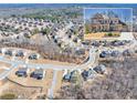 An aerial view of a residential neighborhood featuring a two-story home inset in the upper right corner at 4590 Gablestone Xing, Hoschton, GA 30548