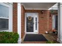Front door with glass features, brick columns, and a decorative wreath welcoming you home at 2958 Stonecrest Ln, Lithonia, GA 30038