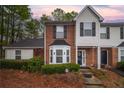 Charming townhome featuring a brick facade, bay window and well-maintained landscaping at 2958 Stonecrest Ln, Lithonia, GA 30038
