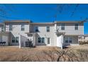 Backyard view of townhomes featuring gray siding, small patios, and a shared lawn area at 402 Whippet St, Union City, GA 30291