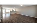 Spacious living room featuring hardwood flooring, neutral paint, and open floorplan to the kitchen at 402 Whippet St, Union City, GA 30291