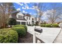Charming two-story home with a white brick exterior, manicured landscaping, and a two-car garage at 6268 Braidwood Nw Run, Acworth, GA 30101
