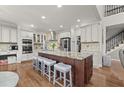 Gourmet kitchen features a center island with seating, stainless steel appliances, and custom cabinetry at 650 Vinings Estates Se Dr, Mableton, GA 30126