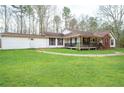 Quaint single Gathering home with a covered porch, beautiful green lawn and peaceful setting at 8951 Brewer Rd, Douglasville, GA 30134