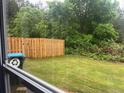 Well-maintained backyard featuring a wooden fence and lush green lawn and view from the window at 312 Lauren Dr, Fairburn, GA 30213