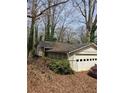 A side view of the home, including the garage and portions of the roofline at 4028 William Mary Ct, Decatur, GA 30034