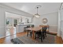 Dining room with a wood table, black chairs, and a view into the updated kitchen at 1835 Tree Top Way, Marietta, GA 30062