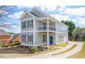 Inviting two-story home with a spacious driveway, second-story balcony, and a manicured lawn at 140 Ryan Ln, Covington, GA 30014