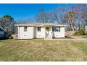 Charming white brick home featuring a well-maintained lawn and inviting front porch at 2976 Emory Se Rd, Smyrna, GA 30080