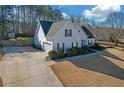 Side view of a charming house with an attached garage and a well-kept lawn at 115 Trelawney Cir, Covington, GA 30016
