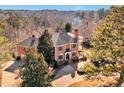 Expansive brick home with mature trees and landscaping, nestled in a serene, wooded setting at 3832 Wesley Chapel Rd, Marietta, GA 30062