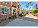 Close-up of the front entrance, highlighting the brickwork, arched doorway, and landscaped walkway at 3832 Wesley Chapel Rd, Marietta, GA 30062