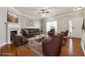 Cozy staged living room with fireplace, stylish furniture, and hardwood flooring at 4550 Cold Spring Ct, Cumming, GA 30041