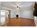 Bright living room with hardwood floors, fireplace, and crown molding at 4550 Cold Spring Ct, Cumming, GA 30041