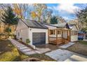 Charming exterior view showcases a quaint front porch and convenient attached garage at 1697 Dyson Ne Dr, Atlanta, GA 30307