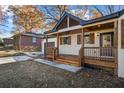Quaint front porch with beautiful wooden accents and a freshly landscaped yard at 1697 Dyson Ne Dr, Atlanta, GA 30307