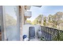 Relaxing outdoor balcony with a chair, decor, and views of the surrounding greenery at 300 Johnson Ferry Ne Rd # A403, Atlanta, GA 30328