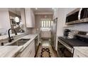 Well-equipped kitchen with stainless steel appliances, white cabinets, and marble countertops at 300 Johnson Ferry Ne Rd # A403, Atlanta, GA 30328