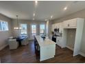 Open kitchen with an island, stainless steel appliances, and dining area at 507 Zeal Street # 334, Atlanta, GA 30315