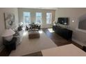 Bright living room with modern decor, large windows, and hardwood flooring at 507 Zeal Street # 334, Atlanta, GA 30315