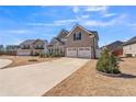 Beautiful home exterior with a long driveway leading to a two-car garage at 1109 Alaska St, Hampton, GA 30228