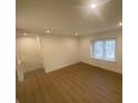 Cozy living room with updated flooring and natural light from the window at 145 Amherst Nw Pl, Atlanta, GA 30327