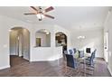 Elegant dining room featuring hardwood floors, an open floor plan, and a view into the kitchen at 326 Lauren Dr, Fairburn, GA 30213