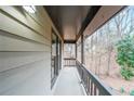 View from the covered front porch showing decorative wood railing and exterior views at 3865 Whitney Pl, Duluth, GA 30096