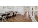 Elegant dining room with hardwood floors, a large table set for six, and an open view to other rooms at 4290 Montberry Ln, Fairburn, GA 30213