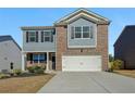Beautiful two-story home featuring a brick and siding exterior, attached two car garage, and a concrete driveway at 4290 Montberry Ln, Fairburn, GA 30213