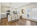 Bright, modern kitchen featuring stainless steel appliances, a granite island with seating, and hardwood floors at 4290 Montberry Ln, Fairburn, GA 30213