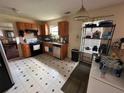 Features gas range, stainless steel dishwasher, and classic wood cabinetry at 5546 Wellborn Creek Dr, Lithonia, GA 30058