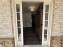 Inviting entryway with a beautiful wooden door, sidelights, and hardwood floors at 3677 Thornhill Ct, Douglasville, GA 30135