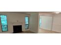 Bright living room with a classic fireplace, large windows, and neutral paint at 4077 Woodridge Way, Tucker, GA 30084