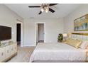 Bright bedroom with ceiling fan, TV, a modern dresser and artwork for a luxury feel at 473 Broder Farms Dr, Stockbridge, GA 30281