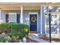 Close-up of the home's entry door with a decorative wreath, tidy landscaping, and covered front porch at 840 Ash St, Canton, GA 30114